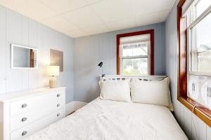 a bedroom with a white bed and a window at Shimmering Seaview in York