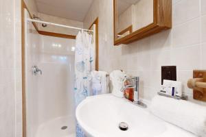 a bathroom with a sink and a shower at Shimmering Seaview in York +47 photos