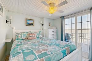 a bedroom with a bed and a ceiling fan at Seas the Day in Wells