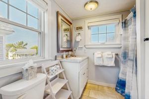 a bathroom with a sink and a toilet and a window at Seas the Day in Wells +47 photos