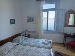 a bedroom with a bed and a large window at Villa Annie in Mythimna
