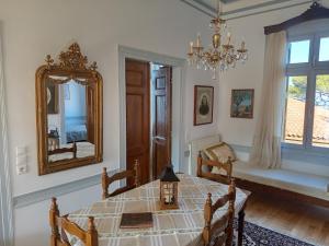 a dining room with a table and a mirror at Villa Annie in Mythimna