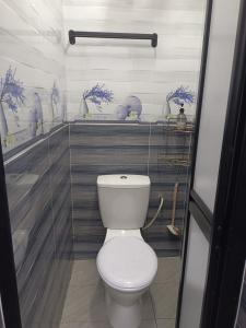 a bathroom with a white toilet in a room at D'Nas Homestay in Rawang +11 photos