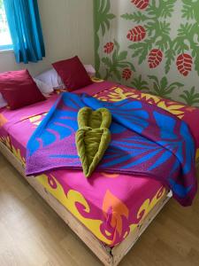 a bed with a heart on top of it at Rurutu Randy in Rurutu