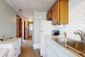 a kitchen with a sink and a refrigerator at Seafoam Dreams in York +29 photos