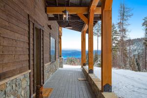 a porch of a house with snow on the ground at La Tierra Lodge in Lakeside
