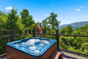 a jacuzzi tub on the balcony of a house at A Tree Top View home in Gatlinburg