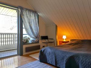 a bedroom with a bed and a large window at Villa Laura in Savonlinna