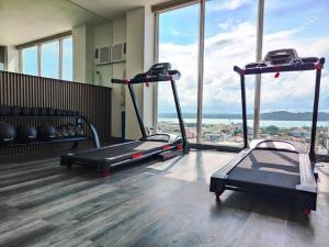 a gym with two tread machines in a room with windows at California style Resident in Iloilo City