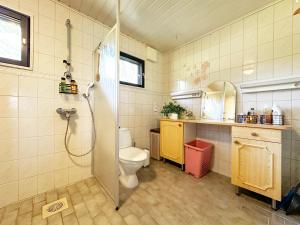a bathroom with a shower and a toilet in it at Villa Laura in Savonlinna +25 photos