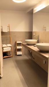 a bathroom with two white sinks on a counter at B&B Sicily Luxury in Catania +153 photos