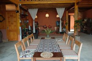 a dining room with a long table with chairs at Hihi Homestay Tả Van - Mountain View & Local Experience in Sa Pa in Tả Van +37 photos