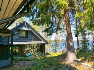 a house with a tree in front of it at Villa Laura in Savonlinna