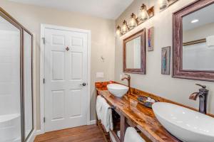 a bathroom with two sinks and a mirror at Lake Dreams in Lakeside +54 photos