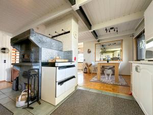 a large kitchen with a stove and a dining room at Villa Laura in Savonlinna