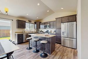 a kitchen with stainless steel appliances and wooden cabinets at Bridger View Retreat in Belgrade