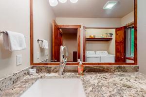 a bathroom with a sink and a mirror at Bigfork Beauty in Bigfork +41 photos