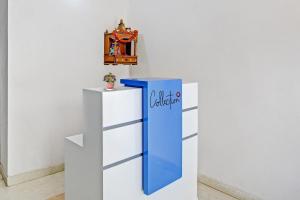 a blue and white stand with a clock on a wall at Hotel O Ethereal Inn in New Delhi +21 photos