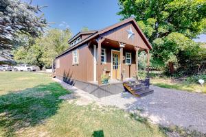 a small house with a star on it in a yard at The Montclair Drive Delight in Kalispell