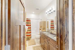 a bathroom with a toilet and a sink and a mirror at Sparkling Glacier - Suite 202 in Columbia Falls +36 photos