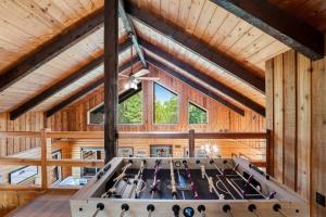 a large room with wooden walls and a ceiling with wooden beams at Log Cabin Lookout in Bigfork