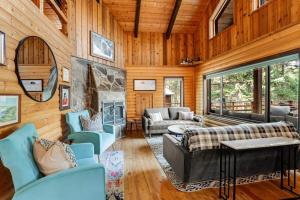 a living room filled with furniture and a fireplace at Log Cabin Lookout in Bigfork +116 photos