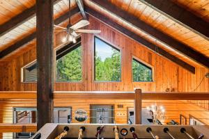 a room with wooden walls and a ceiling with windows at Log Cabin Lookout in Bigfork