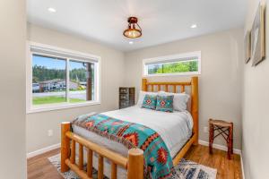 a bedroom with a bed and two windows at Lake Time in Lakeside