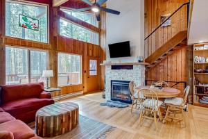 a living room with a table and a fireplace at Lost Trail 101 in Whitefish