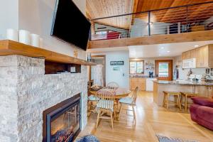 a living room with a fireplace and a dining room at Lost Trail 101 in Whitefish