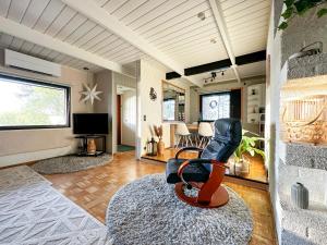 a living room with a chair and a television at Villa Laura in Savonlinna