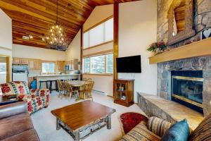 a living room with a couch and a fireplace at Big Horn 19 in Big Sky