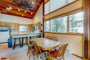 a kitchen and dining room with a wooden table and chairs at Big Horn 19 in Big Sky
