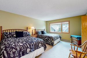 a bedroom with two beds and a window at Big Horn 19 in Big Sky