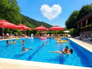 a group of people in the swimming pool at a hotel at Park Hotel Fairy in Chiflik