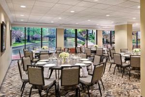 a dining room with tables and chairs and large windows at San Antonio Marriott Riverwalk in San Antonio