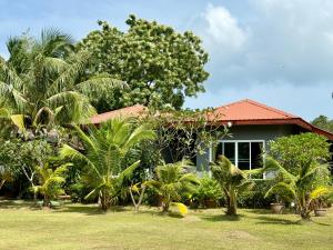 a house with palm trees in front of it at KT Garden Villa in Ko Samui
