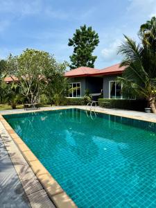 a swimming pool in front of a house at KT Garden Villa in Ko Samui