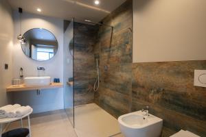 a bathroom with a shower and a sink and a mirror at Hotel Coste in Limone sul Garda +94 photos