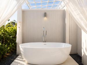 a white bath tub in a bathroom with a window at Sela Lanta in Ko Lanta +28 photos