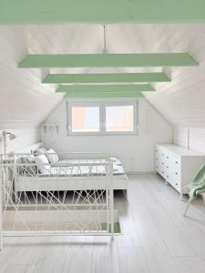 a white room with two bunk beds in it at Helló Zsóry Apartman in Mezőkövesd