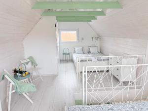 a room with two bunk beds in a attic at Helló Zsóry Apartman in Mezőkövesd