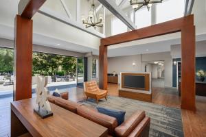 a living room with a couch and a television at Four Points by Sheraton Pleasanton in Pleasanton