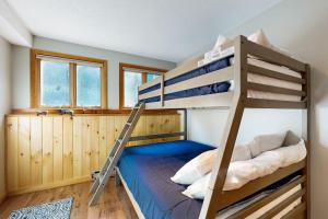 a bedroom with two bunk beds and a ladder at Mountain Memories in Bartlett