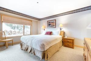 a bedroom with a large bed and a window at Shoshone 1965 in Big Sky +44 photos