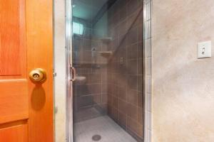 a shower in a bathroom with a glass door at Shoshone 1909 in Big Sky +30 photos