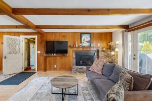 a living room with a couch and a fireplace at Topside Garden in North Conway