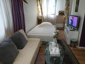 a living room with a couch and a bed at Graeff luxury Apartment in Cologne
