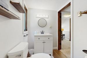 a bathroom with a toilet and a sink and a mirror at Ski & Splash Retreat in Bridgton +56 photos