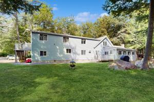 a large white house in a yard at Ski & Splash Retreat in Bridgton